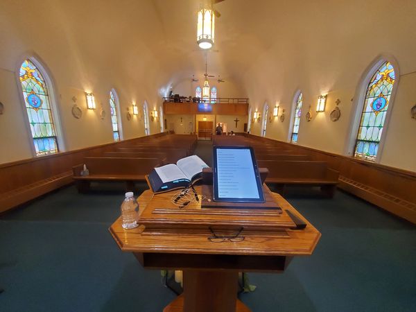 Pulpit with open Bible overlooking the sanctuary